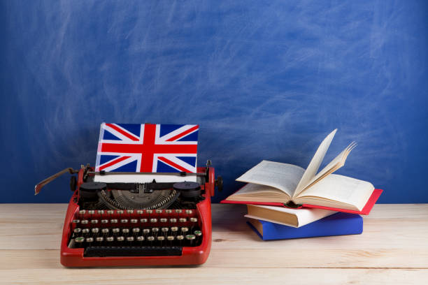 Concepto político, informativo y educativo-máquina de escribir roja, bandera del Reino Unido, libros sobre mesa - foto de stock