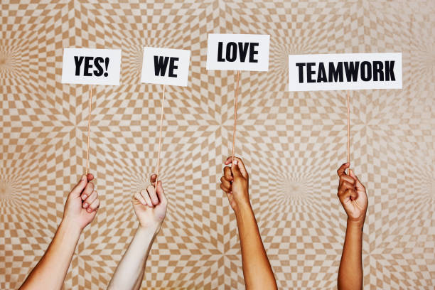 istock Raised hands hold signs reading 