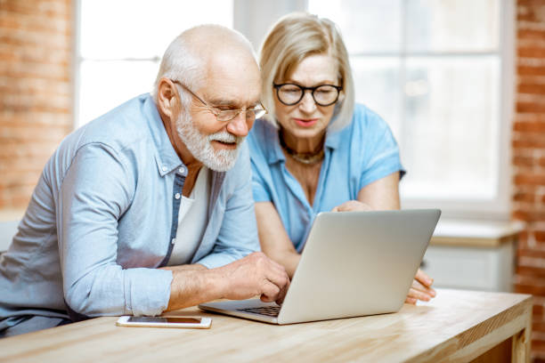 istock Senior couple with laptop at home 1141920540