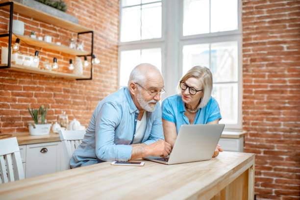 istock Senior couple with laptop at home 1141920547