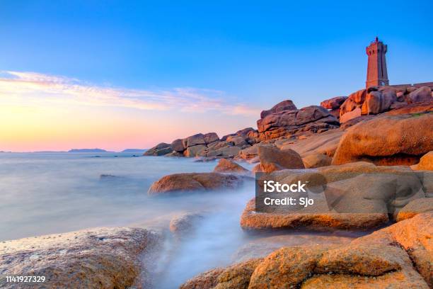 Ploumanach Lighthouse At The Pink Granite Coast In Brittany France During Sunset Stock Photo - Download Image Now
