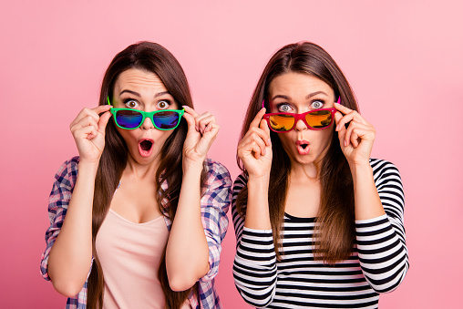 Portrait of cute pretty cheerful fellows fellowship impressed by information sales discounts have eyeglasses open mouth screaming shouting isolated wear spring outfit on pink background.