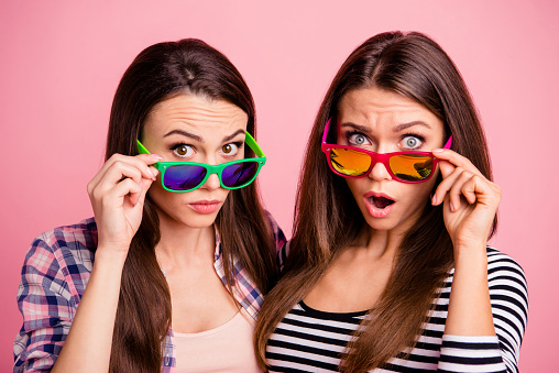 Portrait of nice charming students impressed by incredible information open mouth wearing eyewear eye glasses isolated fashionable clothing on pink background.