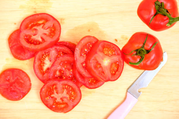 istock close up fresh tomato slice on wood background 1141930661