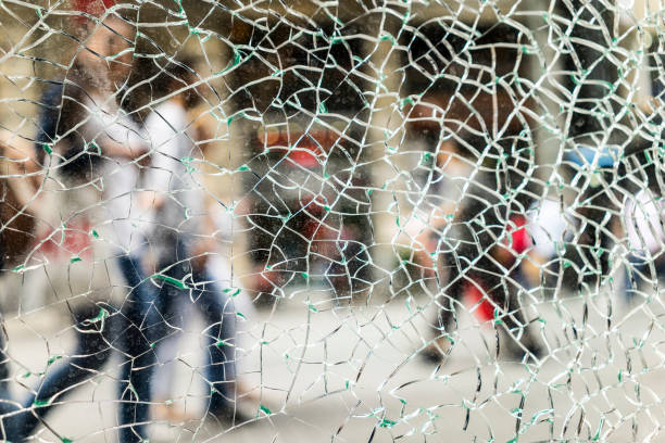 istock Street and Walking People Behind the Broken Glass 1141931565