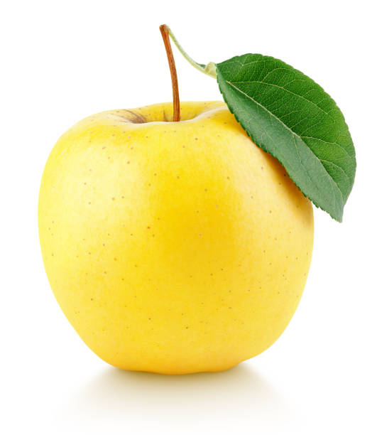 Yellow apple fruit with green leaf isolated on white
