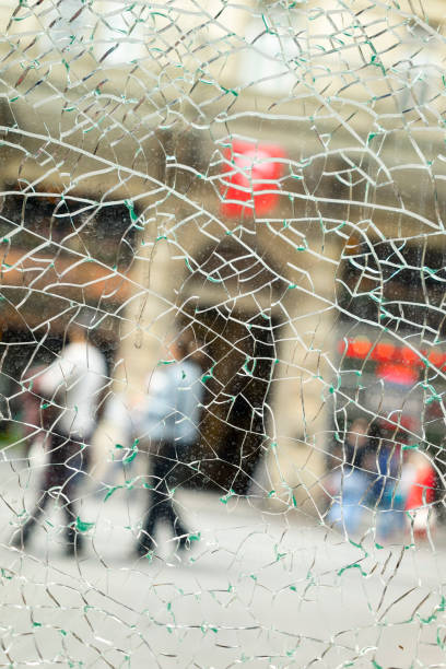 istock Street and Walking People Behind the Broken Glass 1141932169