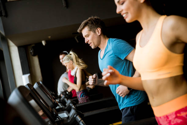istock young people running on treadmills in modern gym 1141935348