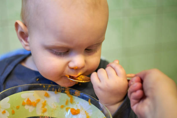 istock Little baby learn to eat by yourself with a spoon 1141935623