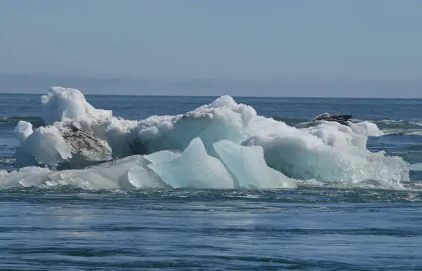 Stunning view of a large iceberg with sediment in a lagoon