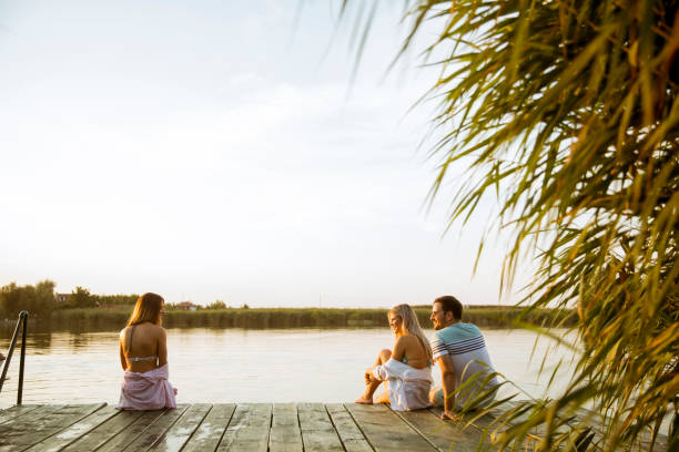 istock Young people having fun at the lake on a summer day 1141938873