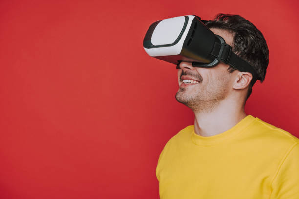 istock Low angle of man looking at something while situating in virtual reality 1141939186