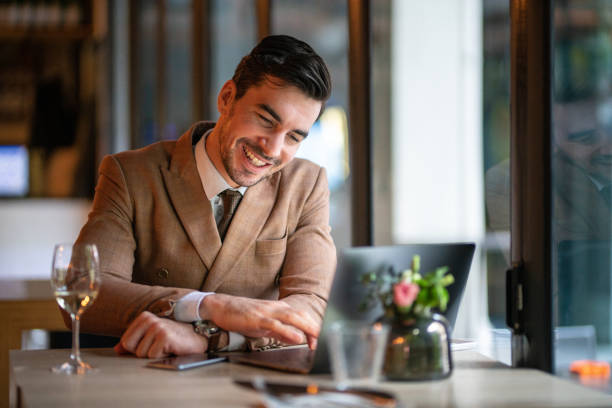 istock Cheerful businessman using laptop in restaurant 1141939415