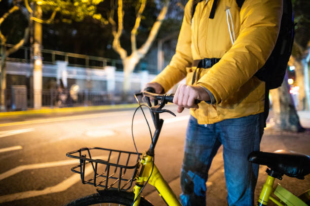 istock Unrecognizable man holding bicycle on the street 1141940416