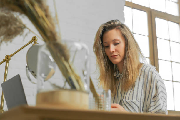 istock serious gloomy woman at the table 1141940433