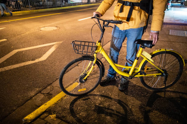 istock Unrecognizable man holding bicycle on the street 1141940593