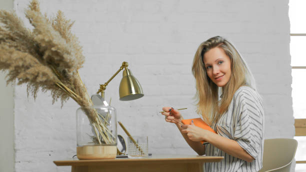 istock pretty woman is doing some work at the table 1141940641