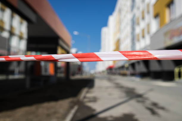 istock Red and white hazard tape on red and white cones 1141944061