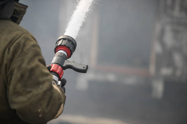 istock Fireman spraying water in a smouldering burnt out house 1141945097