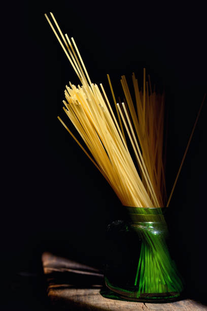 Sunlight and Italian spaghetti on black background
