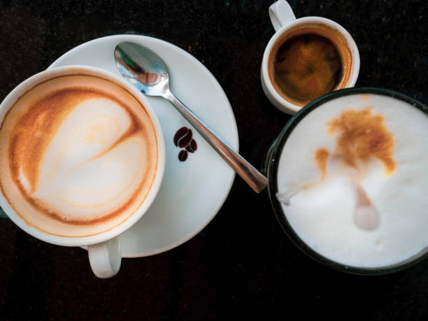 istock Coffee latte, black espresso and cappuccino coffee with whipped cream on black table 1141945621