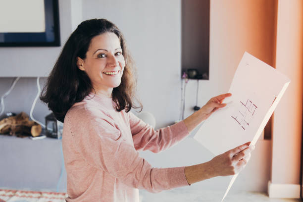 istock Cheerful freelance designer studying apartment layout 1141945948