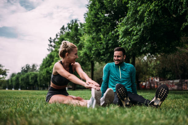 istock Two friends exercising together outdoors. 1141947835
