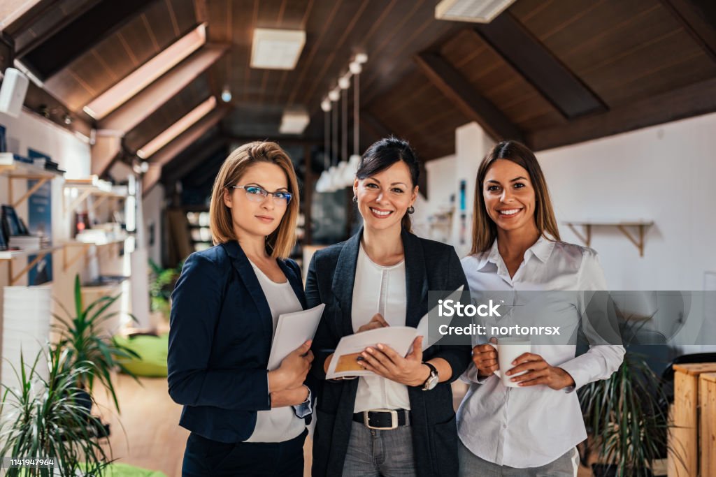 Group portrait of confident female business team. Women Stock Photo