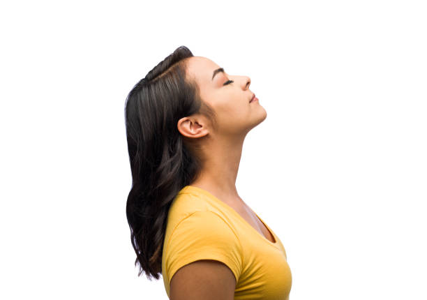 istock Young woman tilting her head upward with closed eyes 1141948260