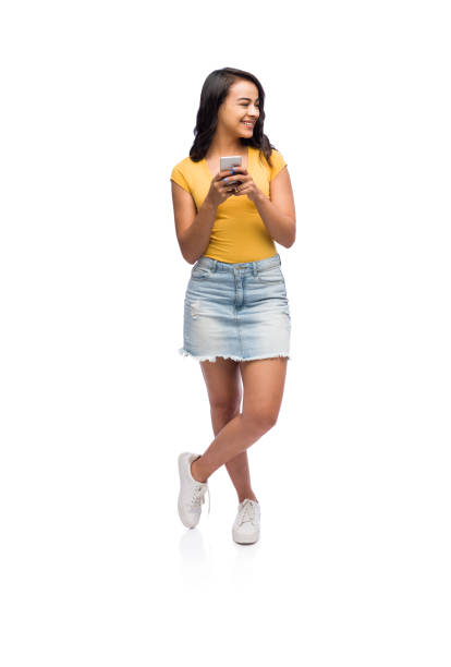 istock Casually dressed girl holding a cellphone 1141948271