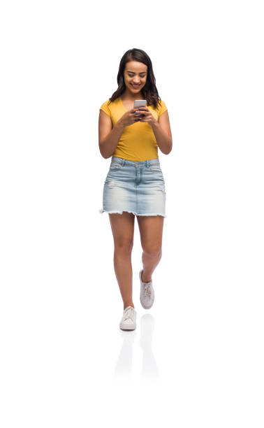 istock Young college girl walking and texting 1141948279