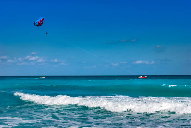 istock Tourists parasailing in Cancun, Mexico 1141948324