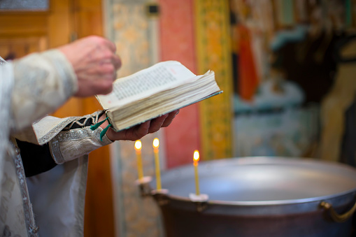 The hands of the priest hold the bible. Orthodox father