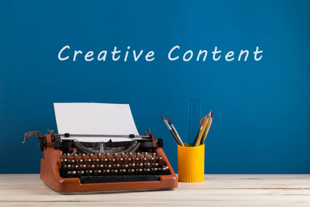 istock writer's workplace - red typewriter and stationery on blue blackboard background with text 