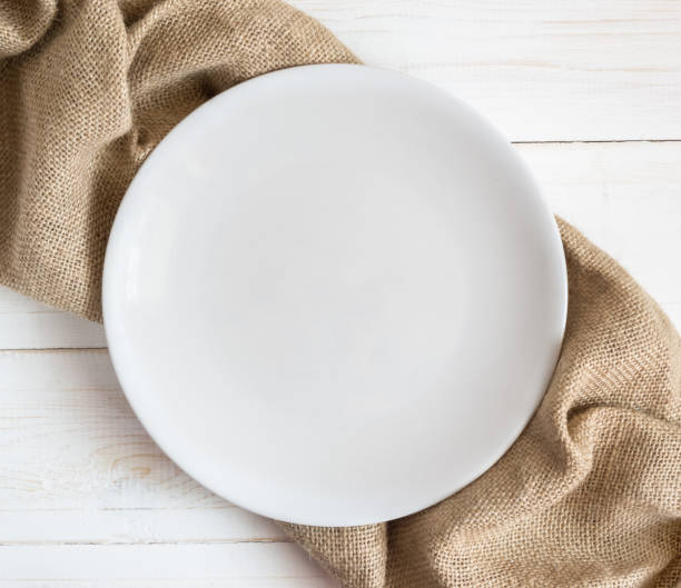 istock White plate on a brown napkin 1141953510
