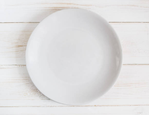 istock Empty white plate on wooden background 1141953528