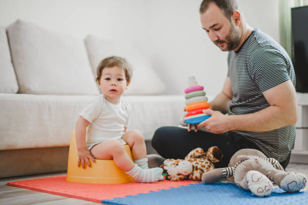 istock Father training his child to use potty 1141954322