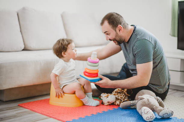 istock Father training his child to use potty 1141954517