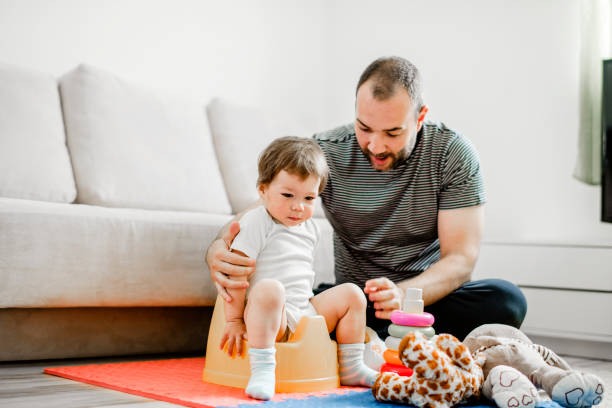 istock Father training his child to use potty 1141954871