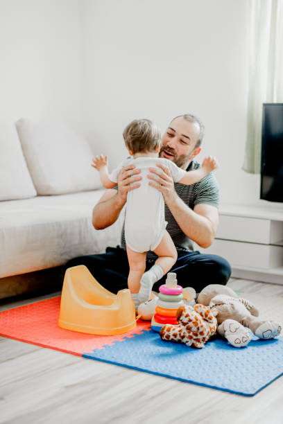 istock Single father spending  time with his baby  in living room 1141955012
