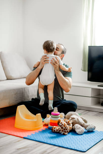 istock Single father spending  time with his baby  in living room 1141955171