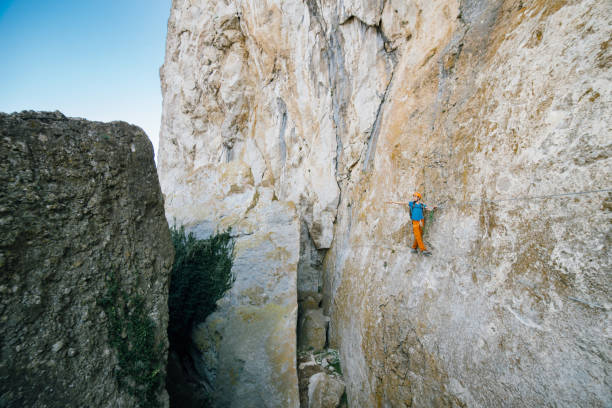 istock Man passing along via ferrata. 1141957100