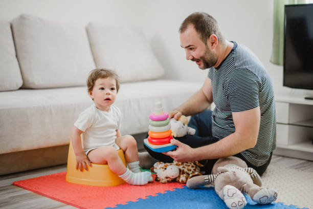 istock Father training his child to use potty 1141957290