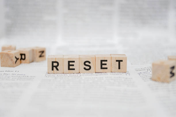 istock Reset Word Written In Wooden Cube - Newspaper 1141958041
