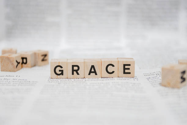 istock Grace Word Written In Wooden Cube - Newspaper 1141958123