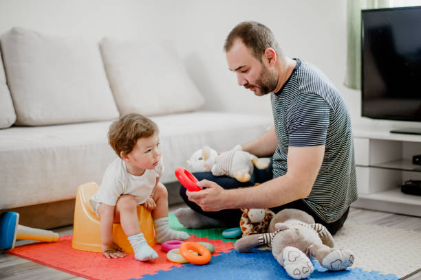 istock Father training his child to use potty 1141958243
