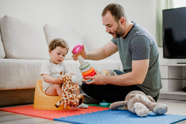 istock Father training his child to use potty 1141958876