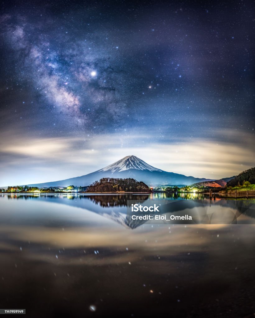 milky way and Mount fuji at night reflected on Lake Kawaguchi, Japan Candid Photo of Snow capped Mount Fuji at night with miky way and Jupiter in the sky, reflected in Lake Kawaguchiko, Yamanashi Prefecture, Japan Mt. Fuji Stock Photo