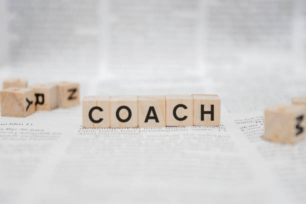 istock Coach Word Written In Wooden Cube - Newspaper 1141959174