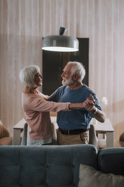 istock Happy elder couple dancing in living room 1141960092